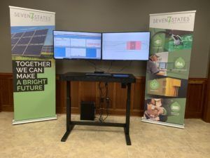 A standing desk with two monitors and a sign that says `` together we can make a bright future ''.