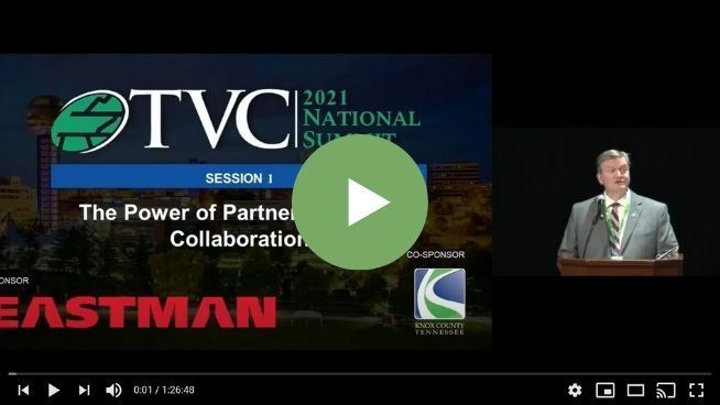 A man is giving a speech at the tvc national summit.