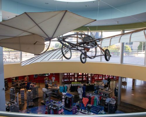 An airplane is hanging from the ceiling of a store