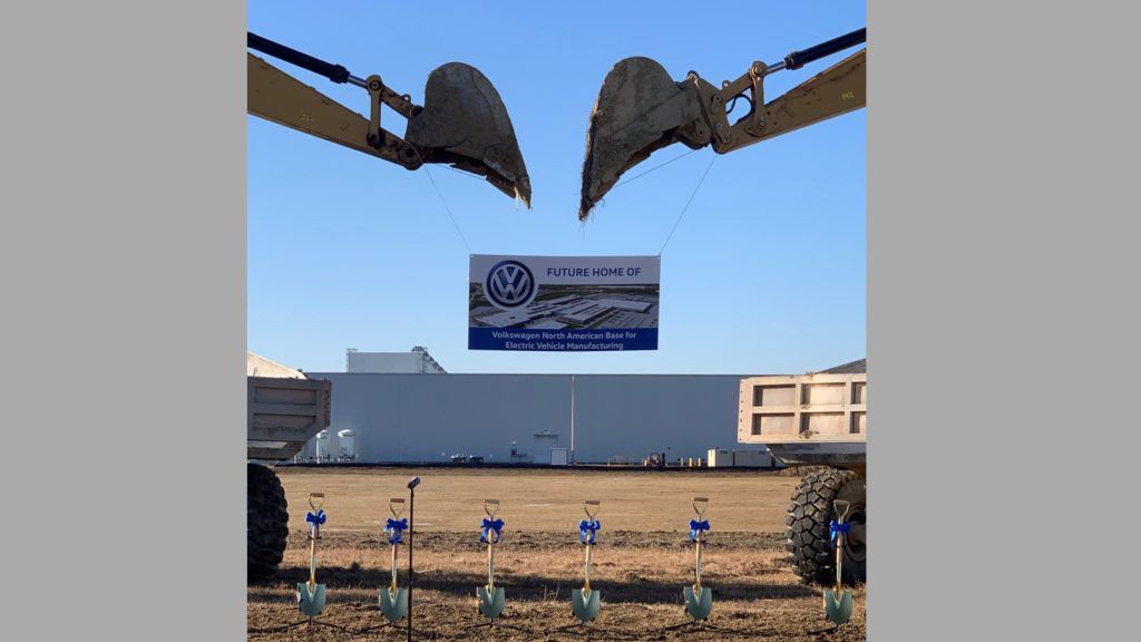 A construction site with shovels and a sign in the background.
