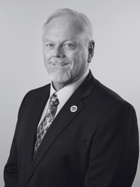 A black and white photo of a man in a suit and tie