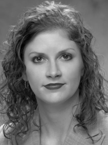 A black and white photo of a woman with curly hair