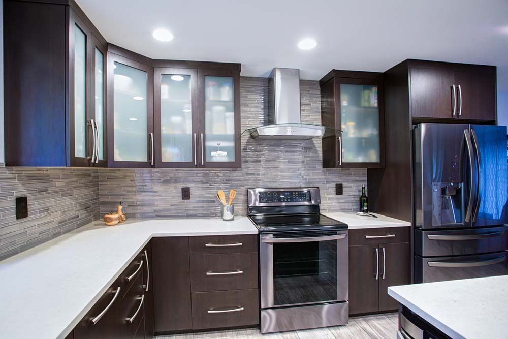 A kitchen with stainless steel appliances and wooden cabinets