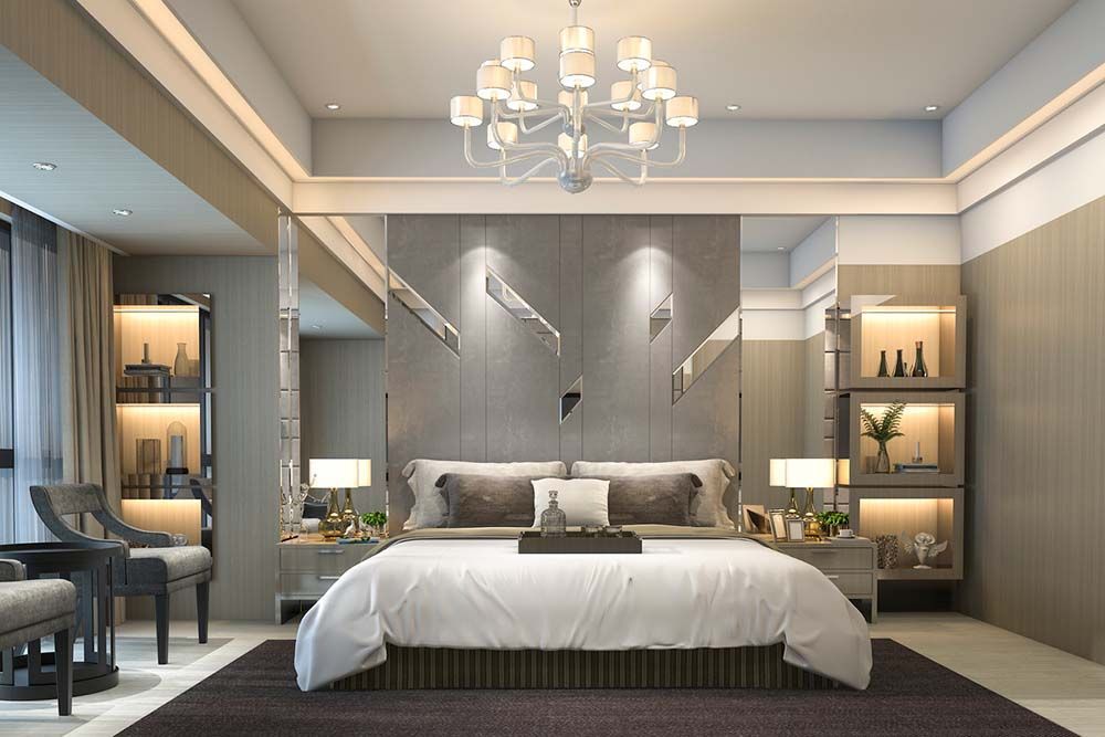 A bedroom with a large bed and a chandelier hanging from the ceiling.