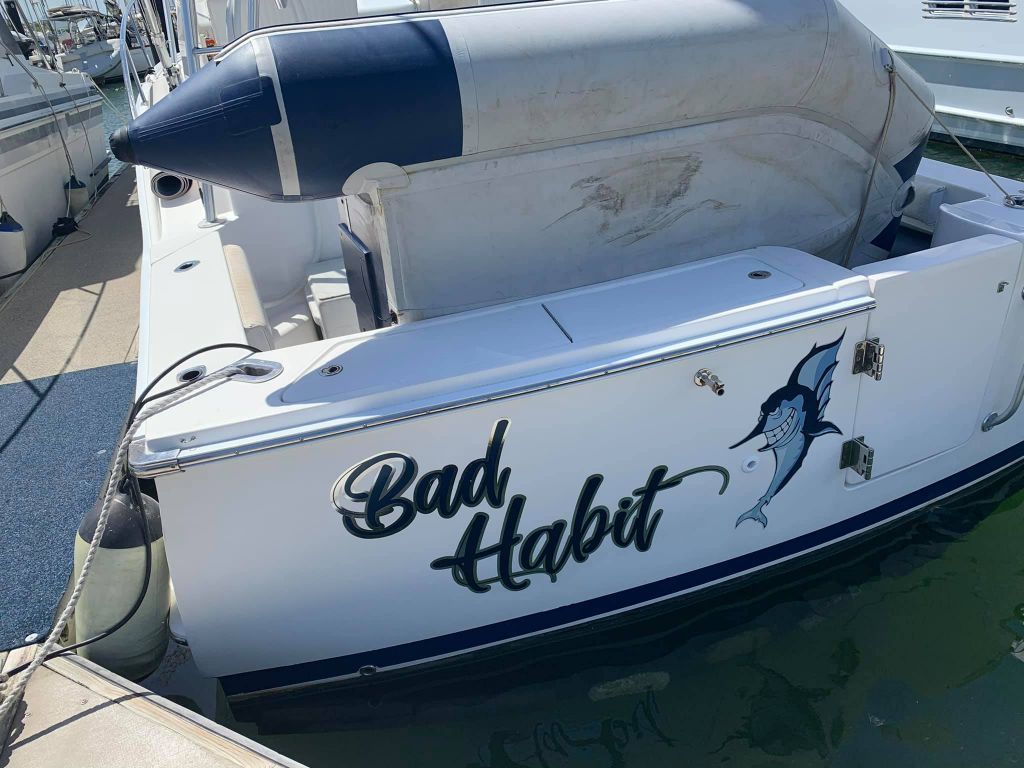 A White Boat With The Words Bad Habit Written On The Side  — Cairns Signcorp In Cairns, QLD