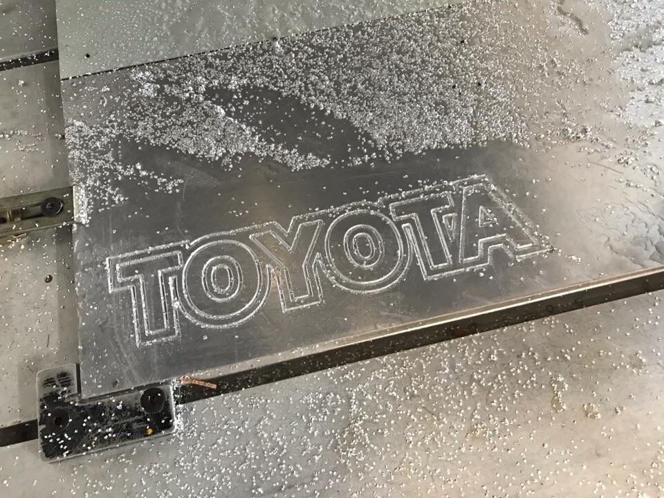 A Toyota Logo Is Carved Into A Piece Of Metal — Cairns Signcorp In Portsmith, QLD