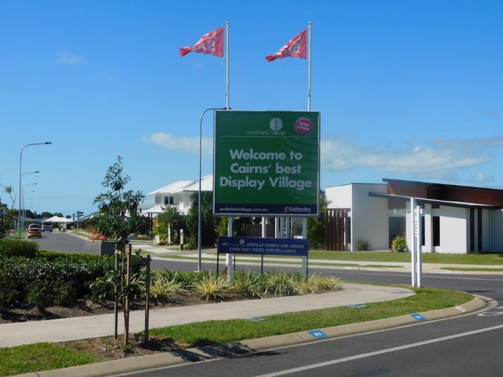 A Green Sign That Says Welcome To Cairns Best Display Village — Cairns Signcorp In Portsmith, QLD