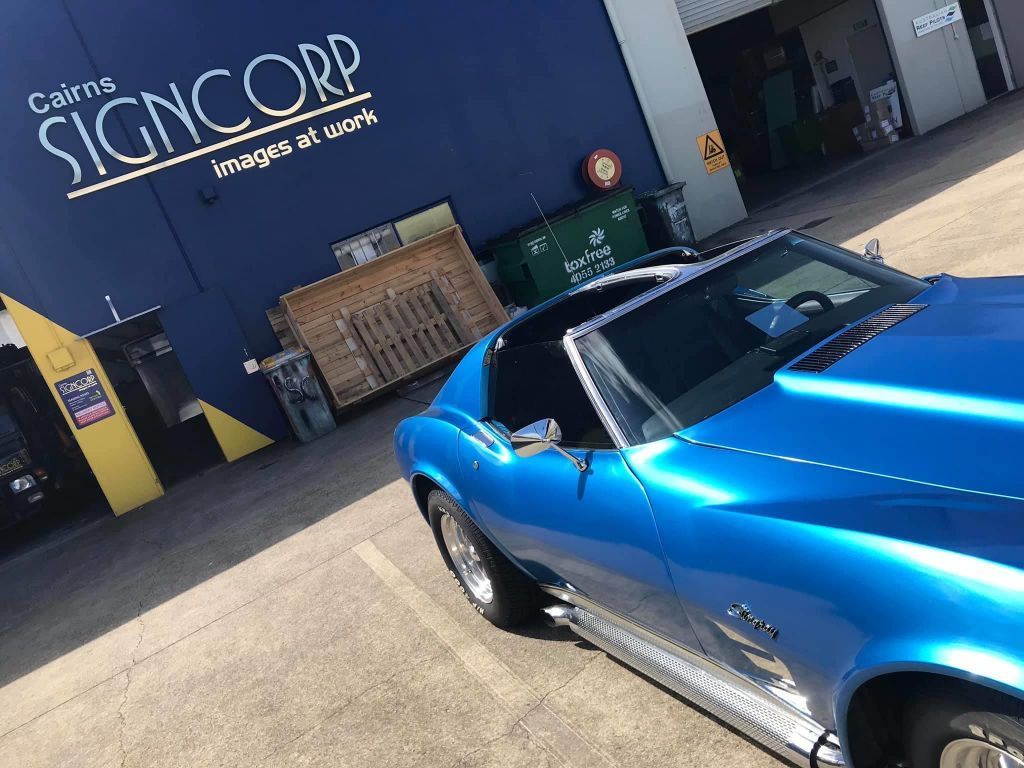 A Blue Car Is Parked In Front Of A Signcorp Building — Cairns Signcorp In Portsmith, QLD