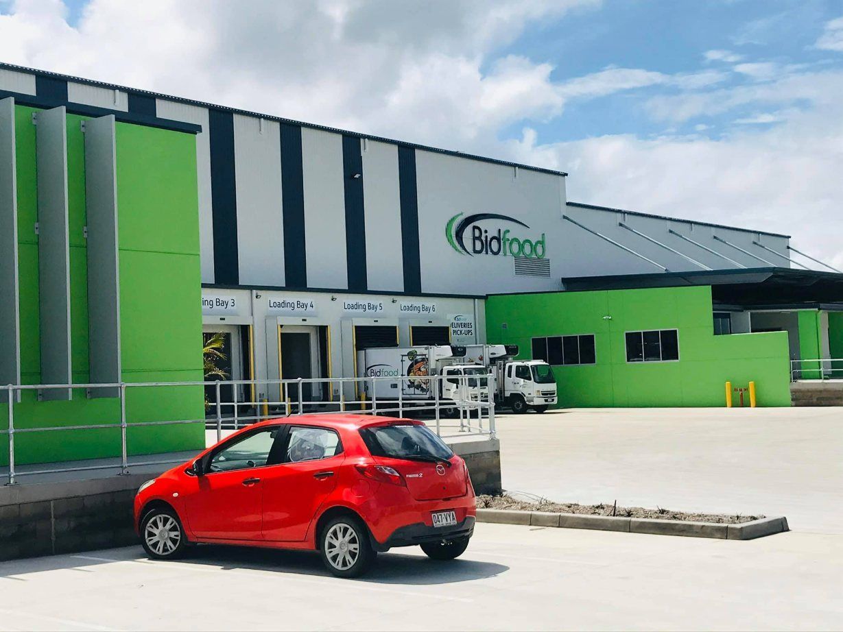 The Front Door Of A Building With A Sign That Says Bidfood On It — Cairns Signcorp In Port Douglas, QLD