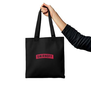 A person is holding a black smirnoff tote bag