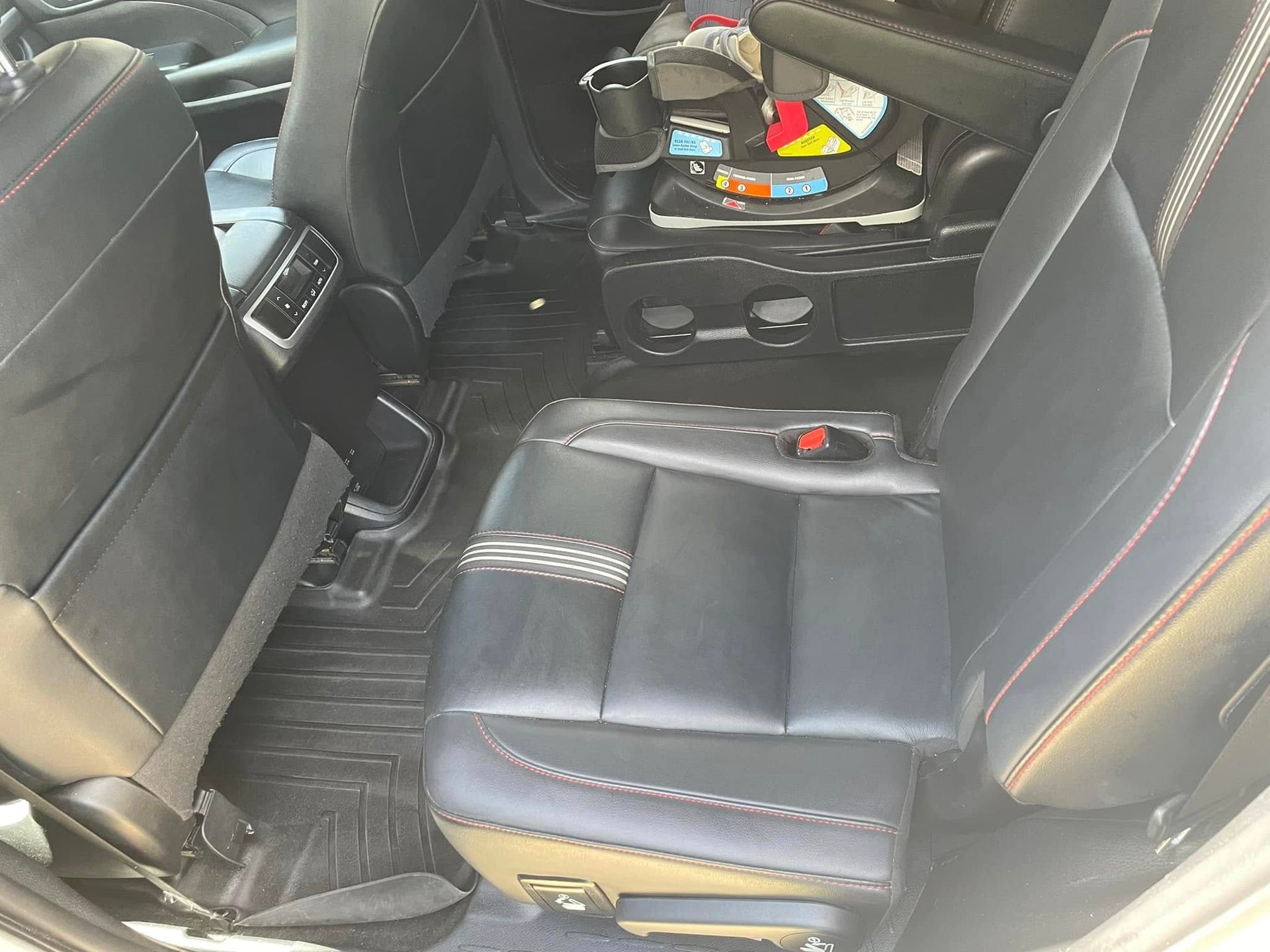 Black leather Toyota car interior with steering wheel, center console, and front seats