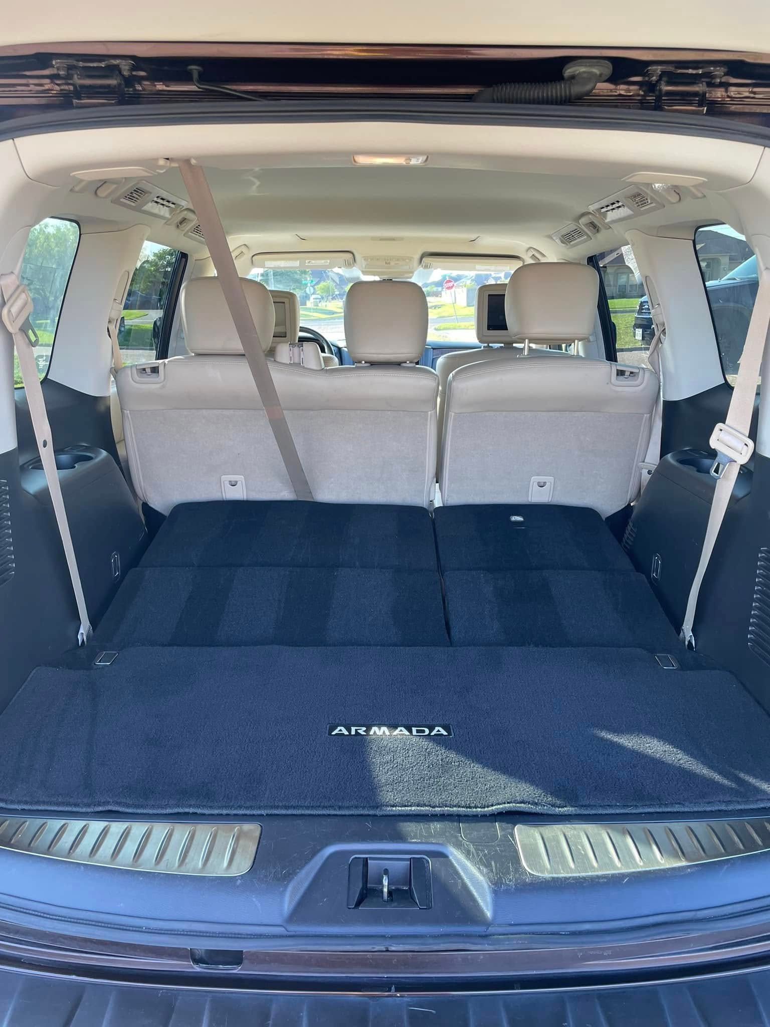 Open SUV cargo area with rear seats folded flat and beige interior.