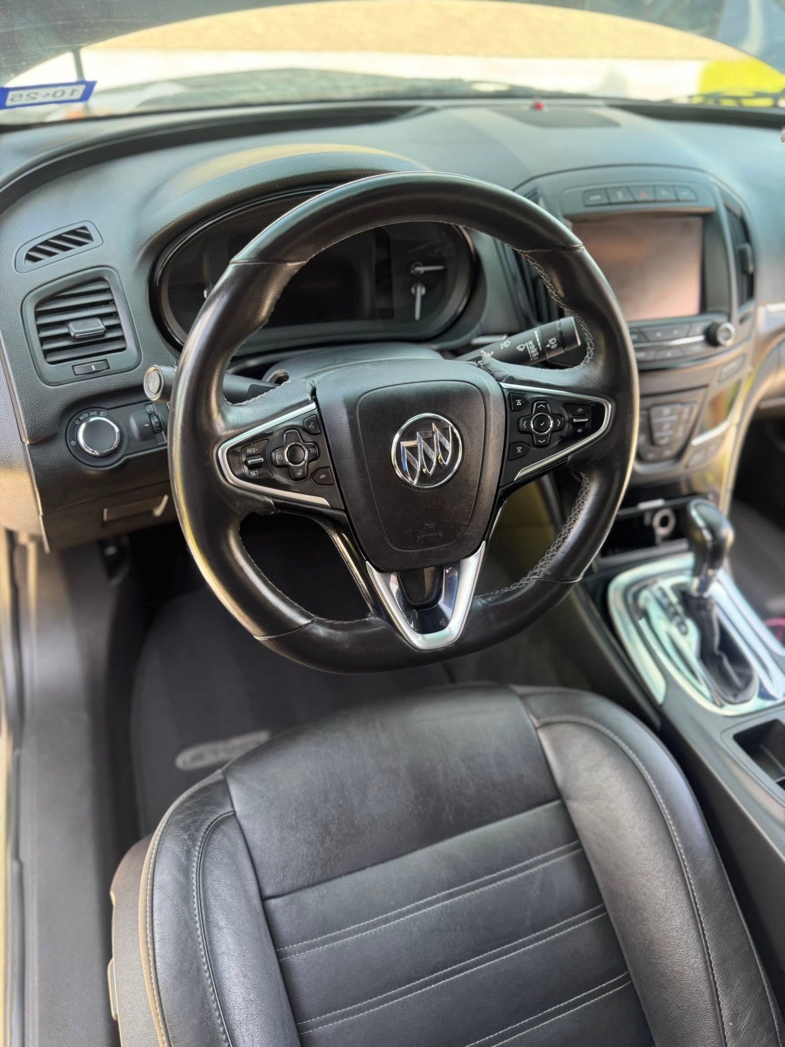 Black leather Toyota car interior with steering wheel, center console, and front seats