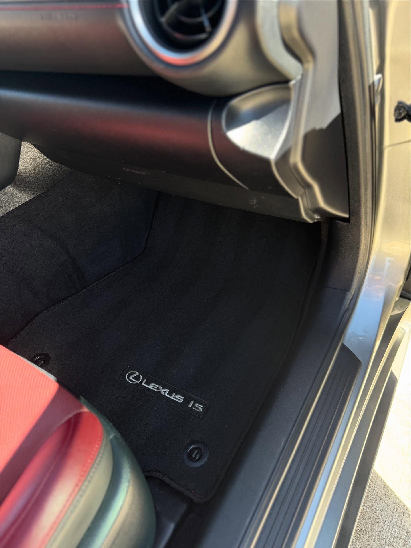 Black leather Toyota car interior with steering wheel, center console, and front seats