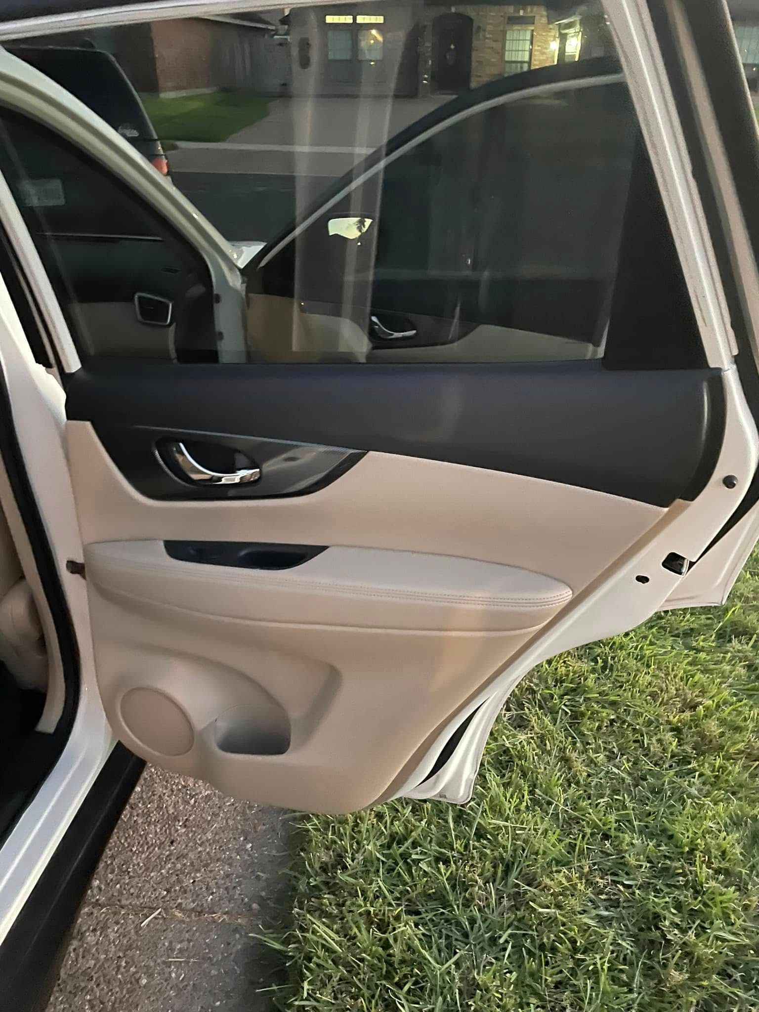 Black leather Toyota car interior with steering wheel, center console, and front seats