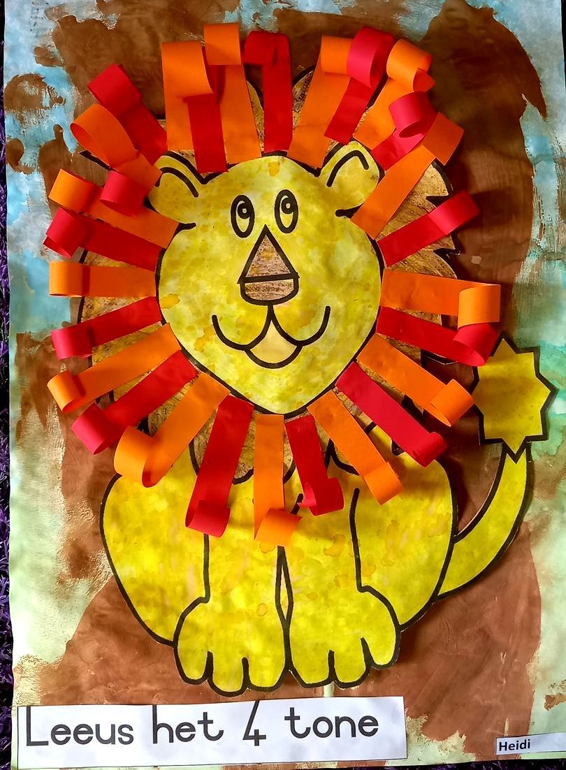 Lion craft with yellow body, orange/red paper mane, and brown background.