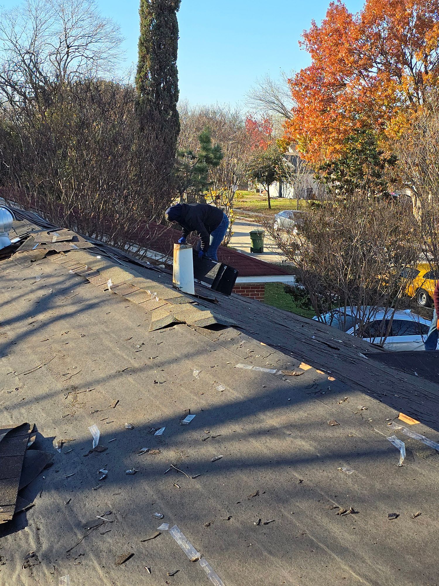 A man is working on the roof of a house.