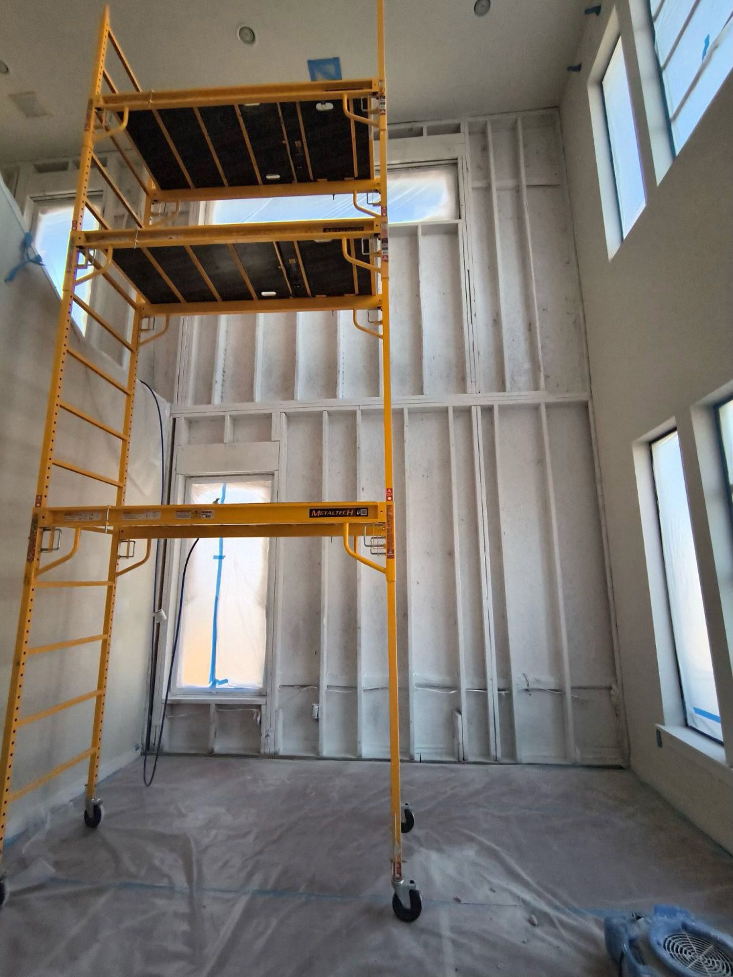 A large room with a scaffolding in the middle of it