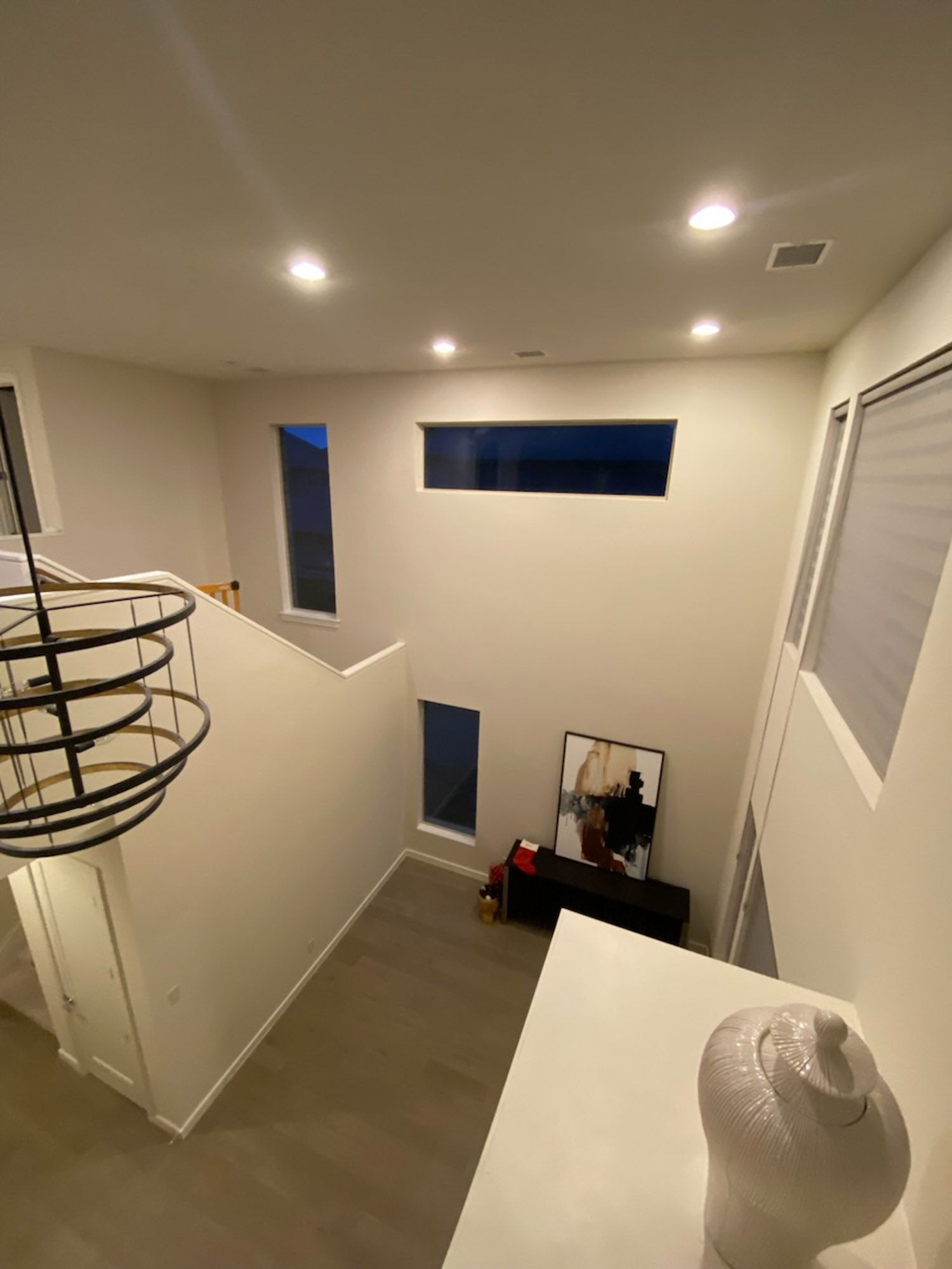 An aerial view of a living room with a staircase leading to the second floor.