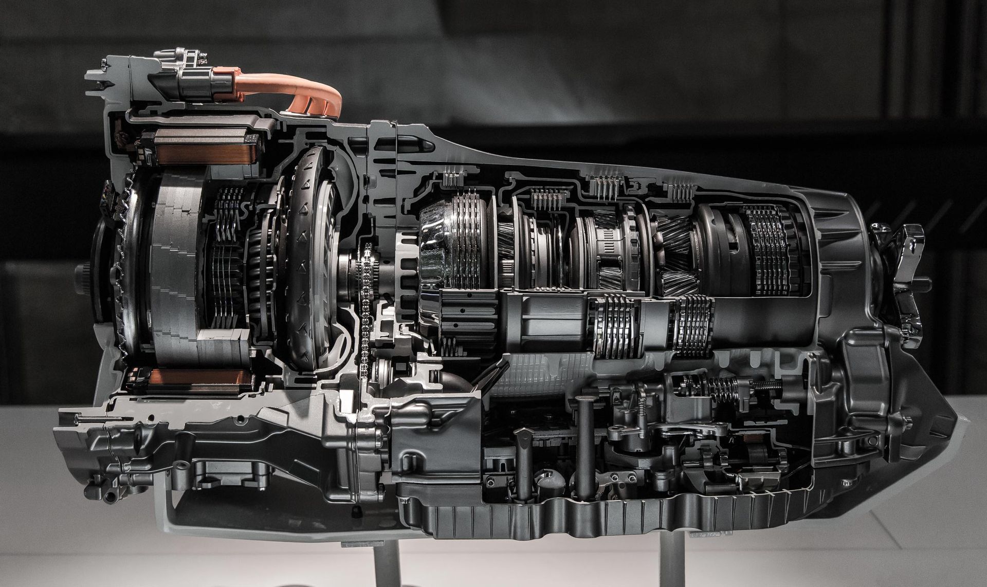 Underside of a vehicle, showing the engine and exhaust system with rust and components.