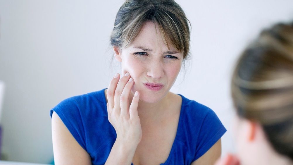 woman suffering from tooth pain