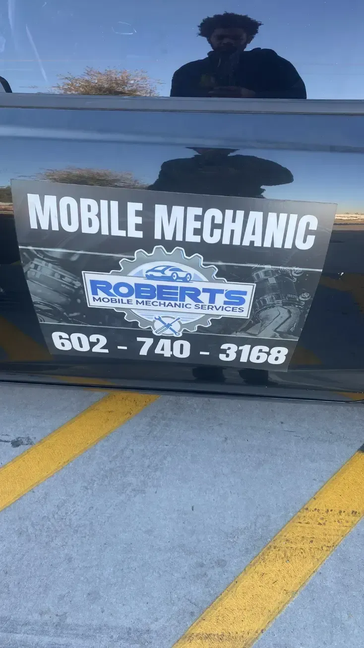 Trailer sign reading “MOBILE MECHANIC” and “ROBERTS” with phone number 602-740-3168