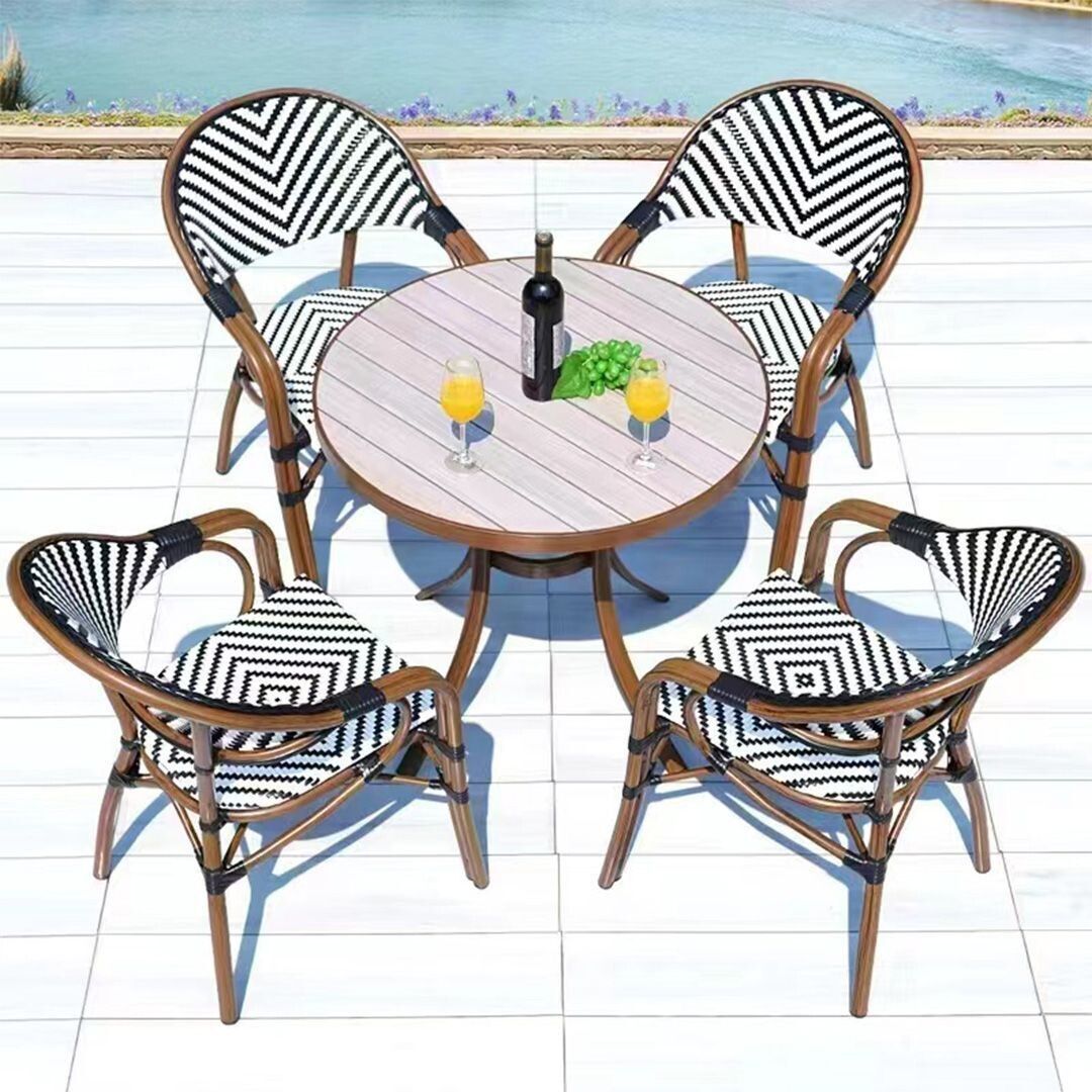 A table with a bottle of wine and two glasses of orange juice on it.