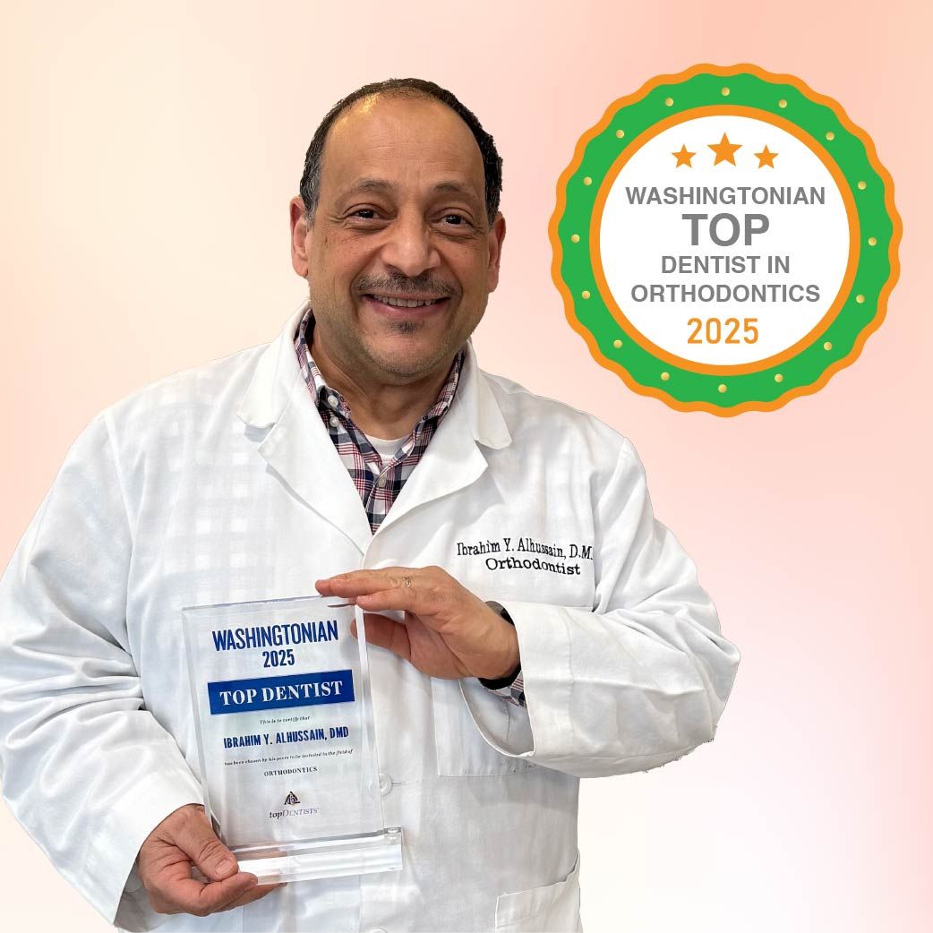 Smiling dentist holding an award,