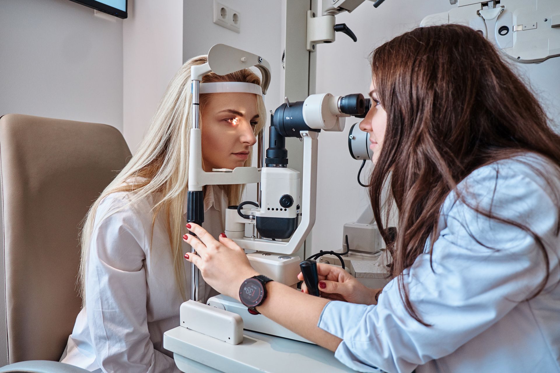 A doctor is checking the eyes of a patient.