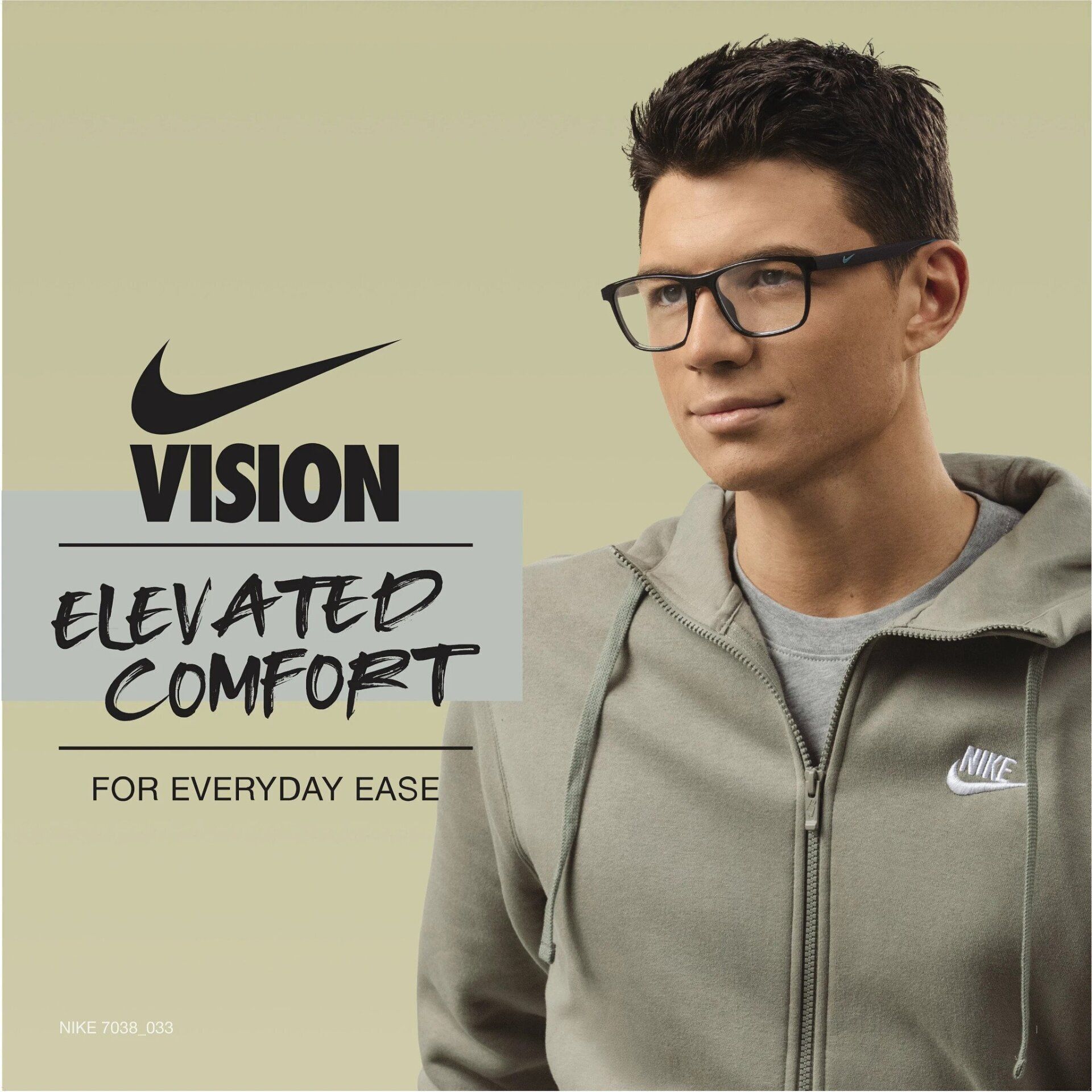 A man wearing Nike glasses and a green zip-up hoodie. The Nike Vision logo and text