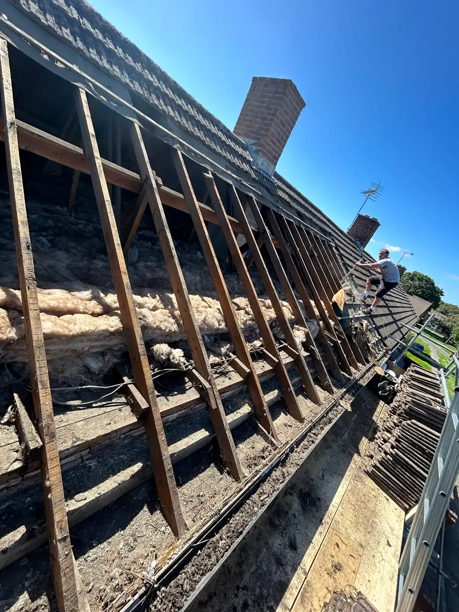 A man is working on the roof of a building.