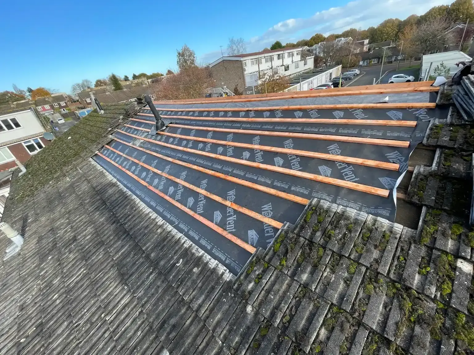 An aerial view of a roof that is being repaired.