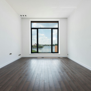 A retail display featuring a stack of various wooden flooring sample planks in shades ranging from cream to dark brown.
