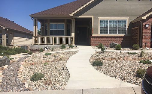 A house with a concrete walkway leading to it