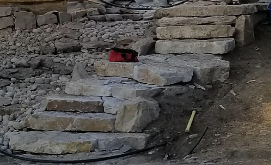 A Staircase Made of Rocks is Being Built in the Dirt