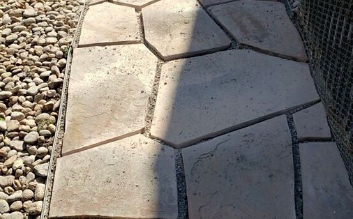 A stone walkway surrounded by rocks and gravel.