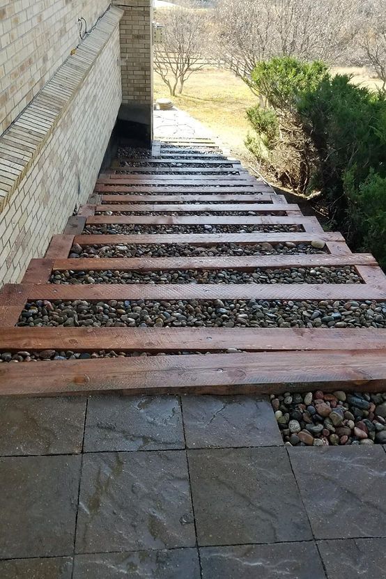 A Wooden Walkway Leading Up to a Brick Building