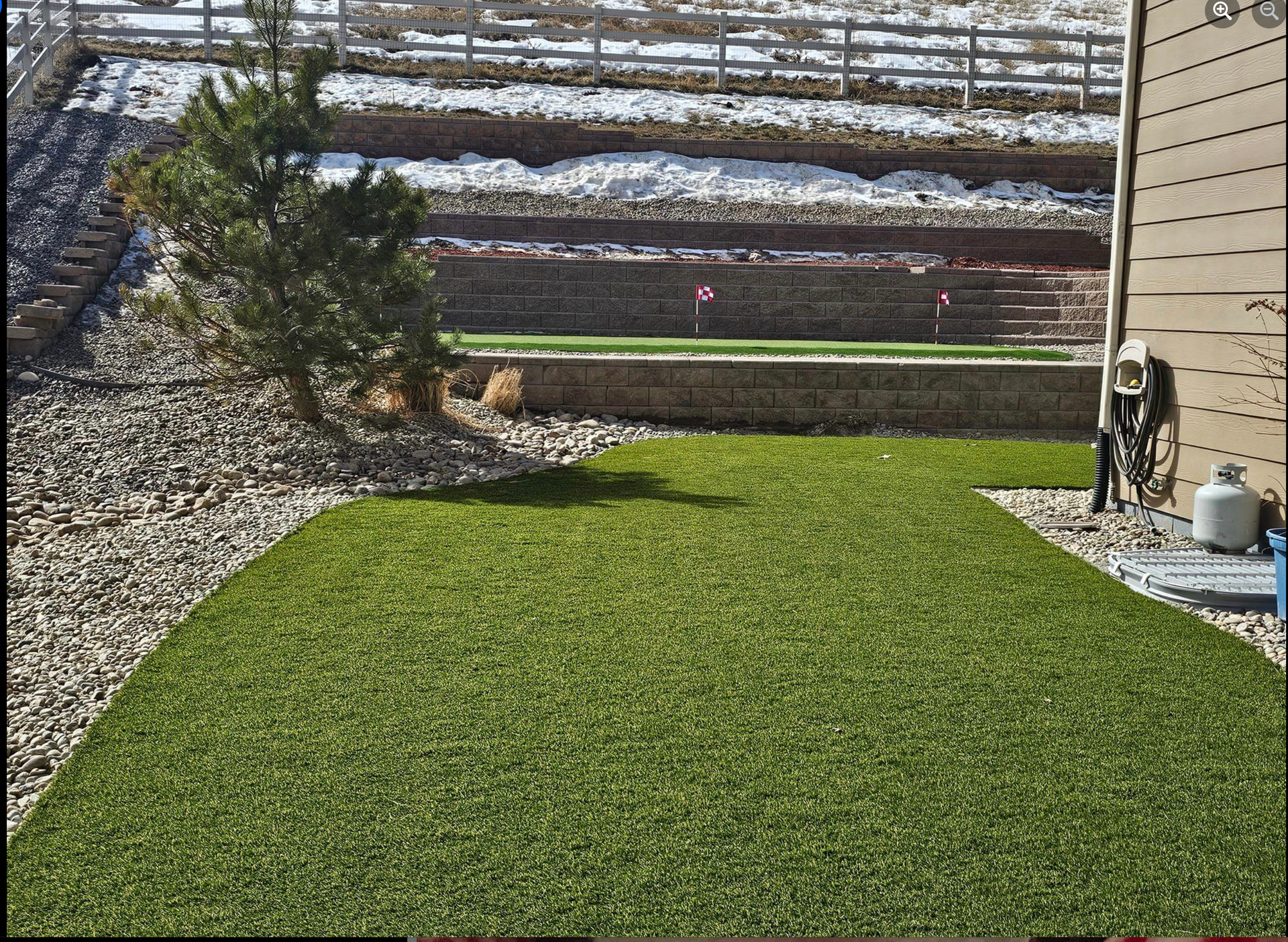 A lush green lawn in front of a house