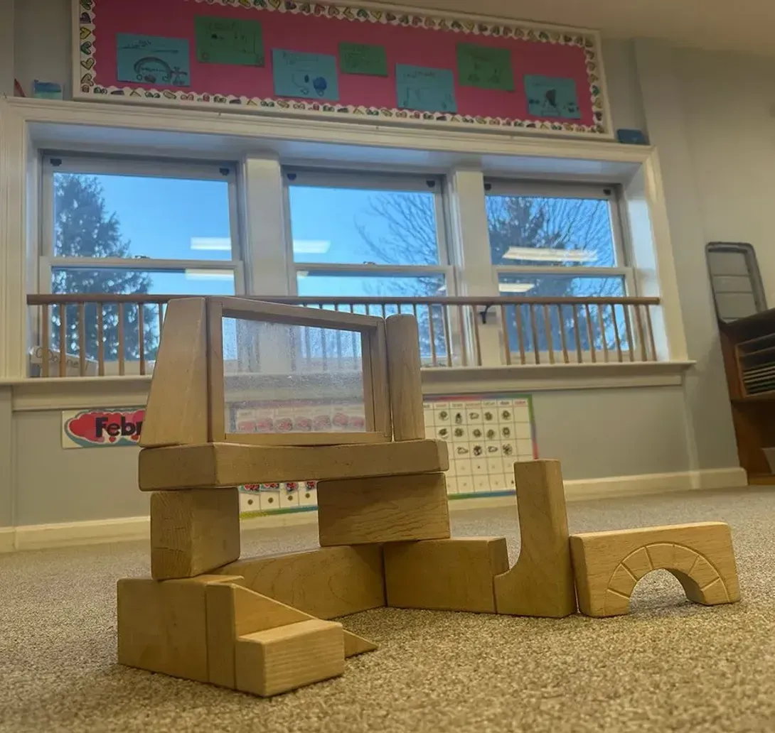two kids are playing in barn yard child care center
