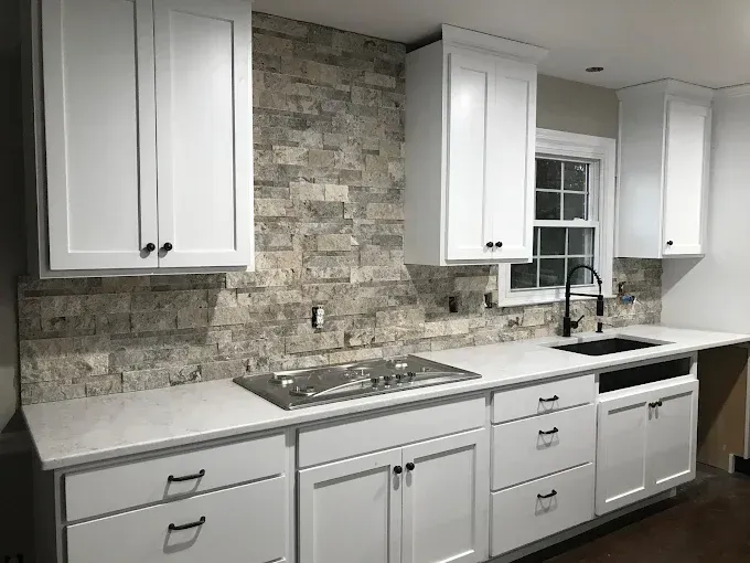 Kitchen with white cabinets, granite countertops, and stainless steel appliances.
