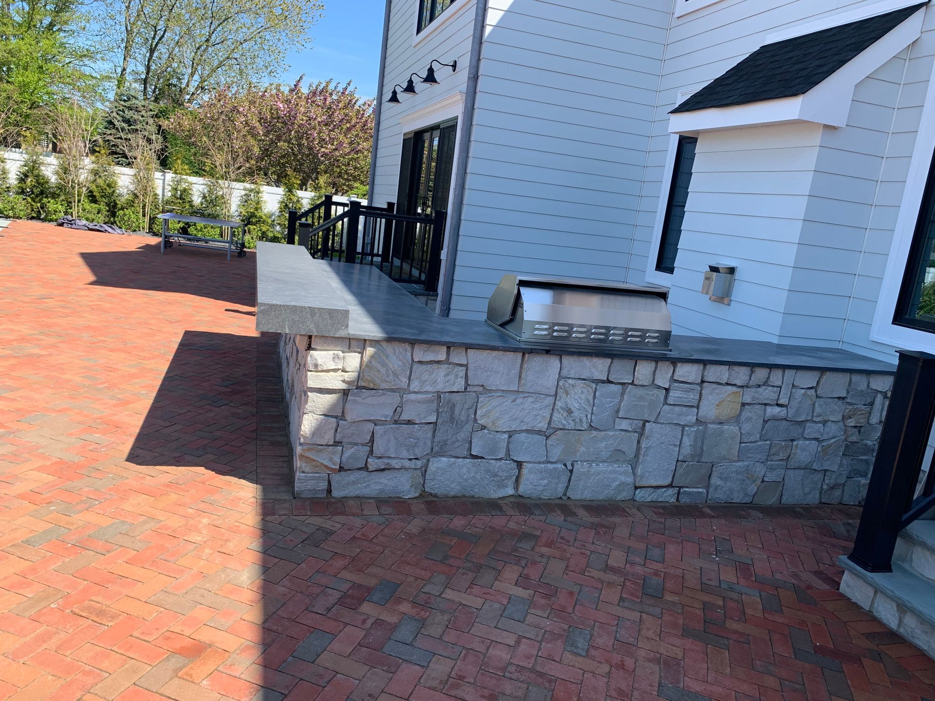 White House with Stone Wall and Grill — Westbury, NY — A&M D’Alessandro Contractors Inc. 