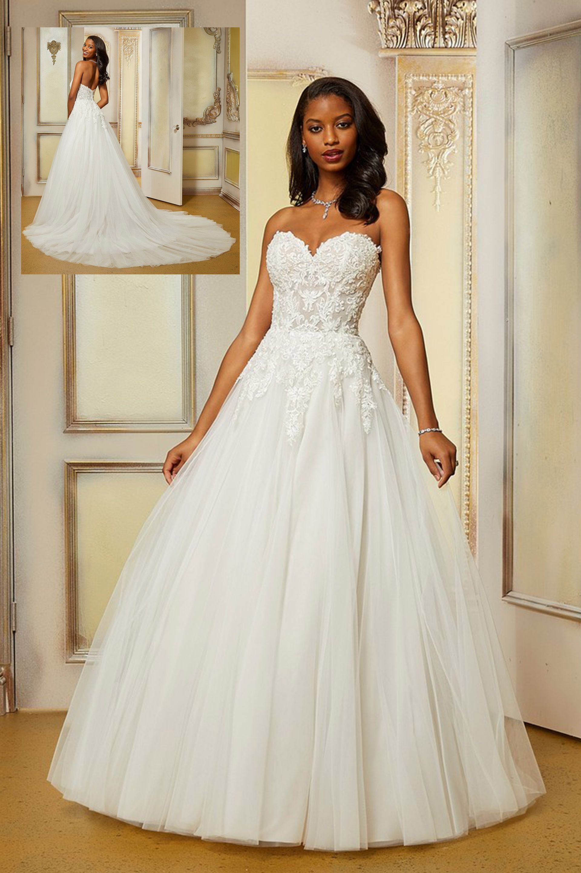 Una donna in abito da sposa bianco è in piedi in una stanza.