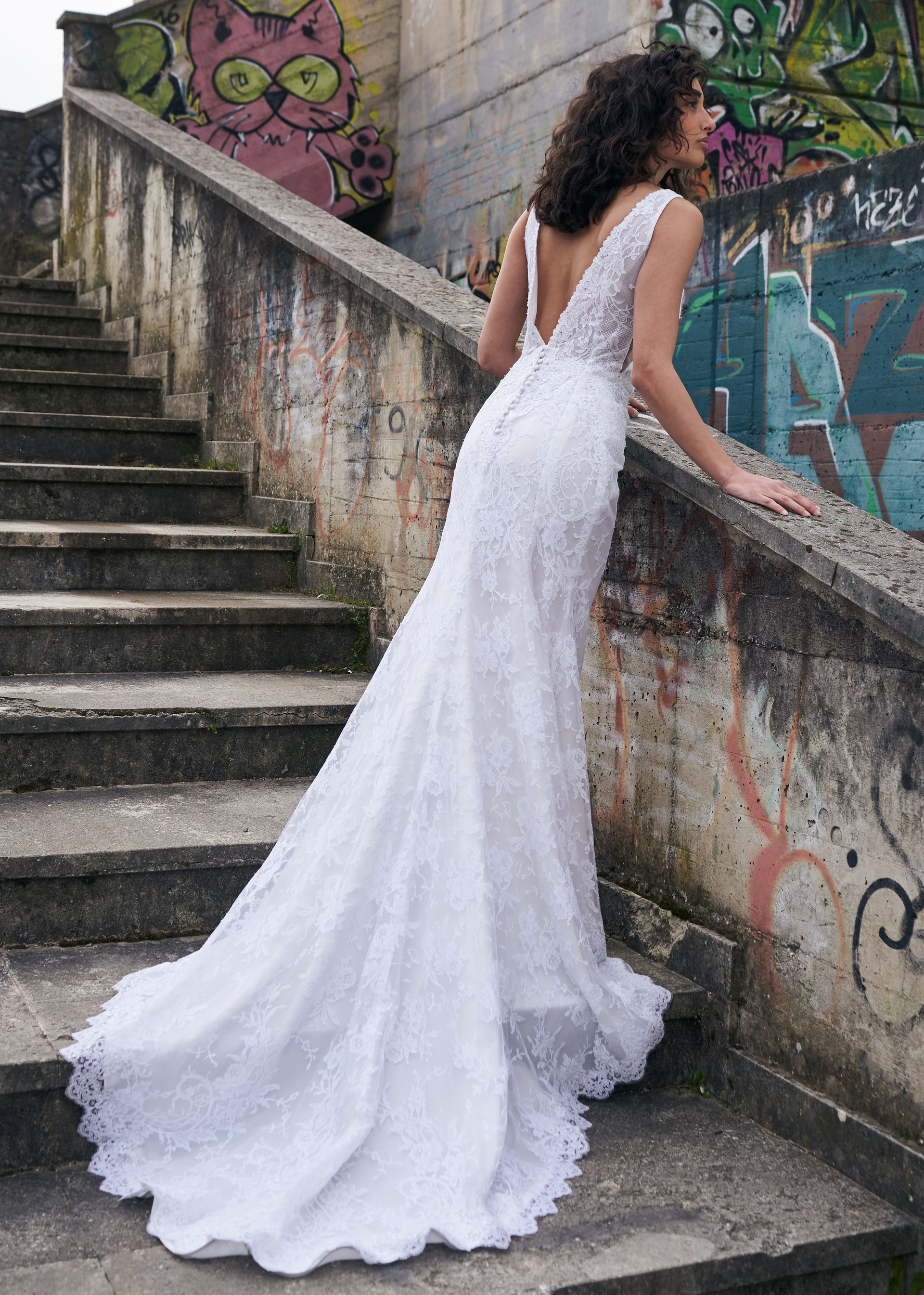 Una donna in abito da sposa è in piedi su una rampa di scale.