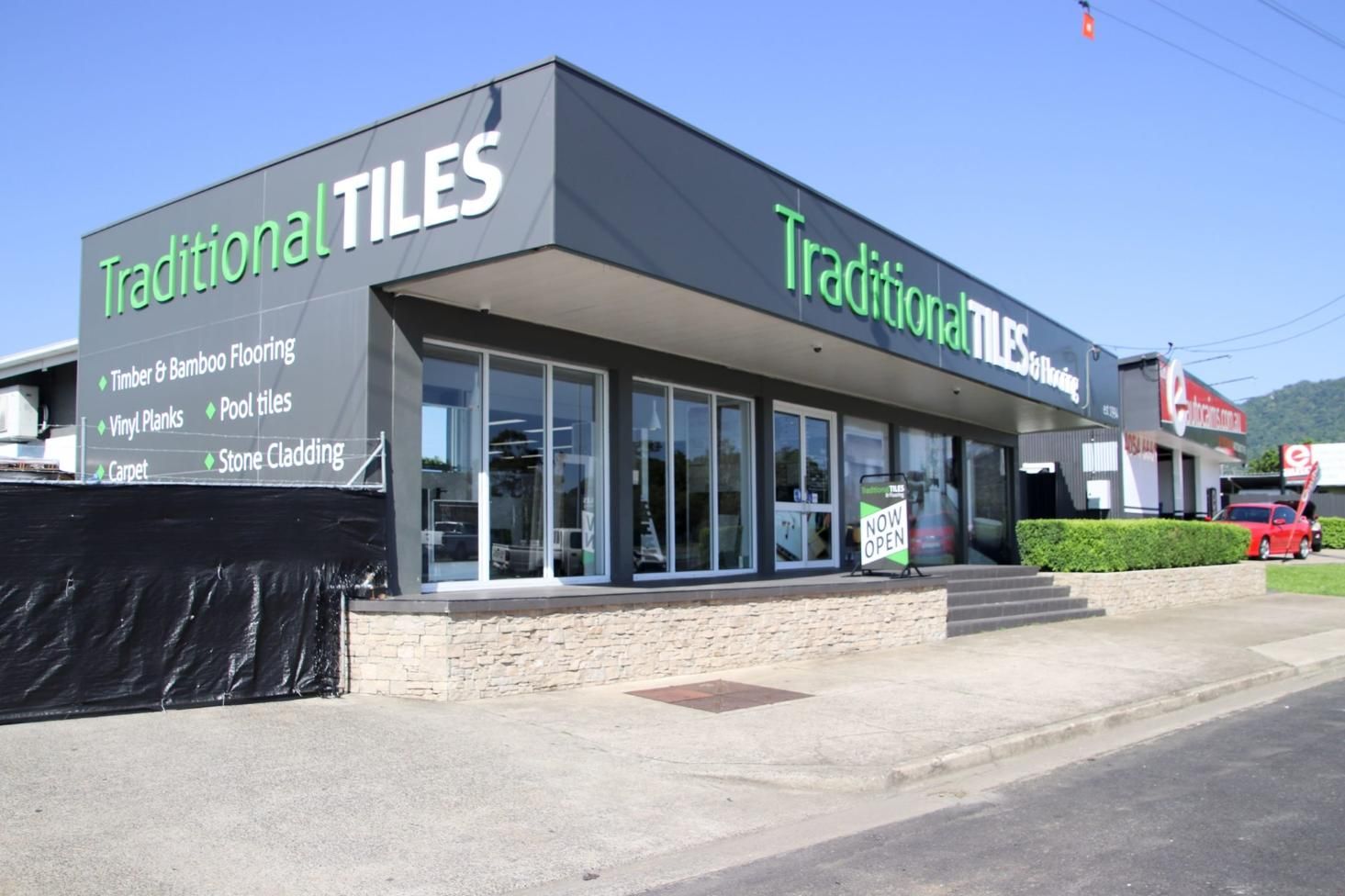 A Building With a Sign That Says Traditional Tiles on It — Traditional Tiles & Flooring In Woree, QLD