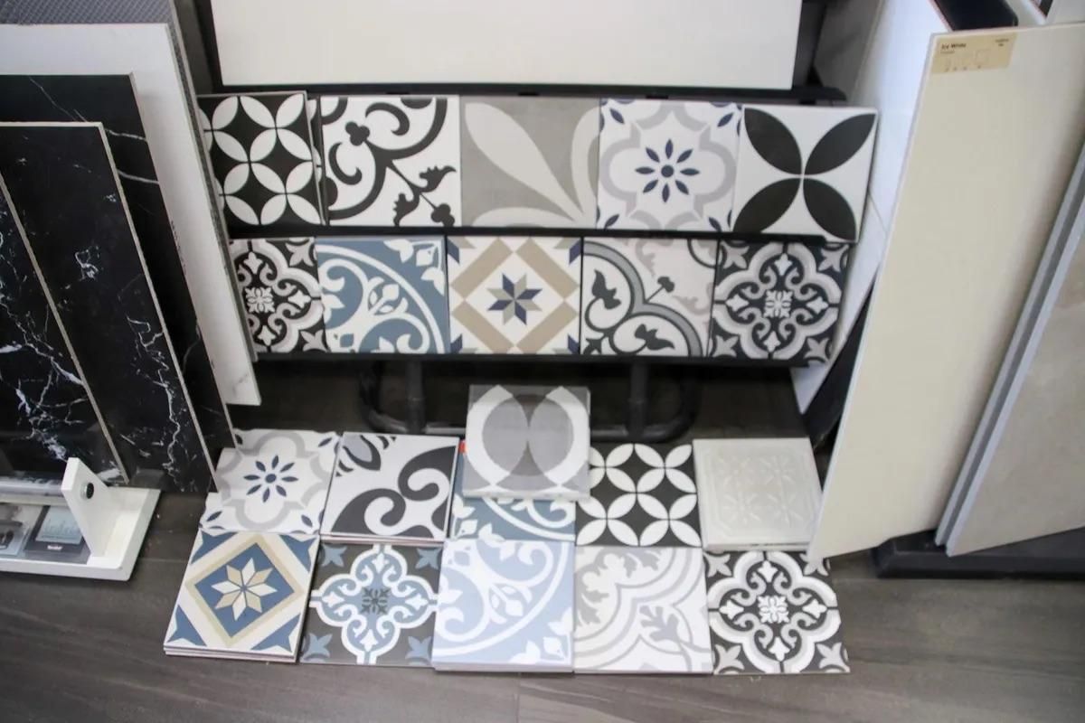 A Bunch of Tiles Are Sitting on a Wooden Floor — Traditional Tiles & Flooring in Gordonvale, QLD