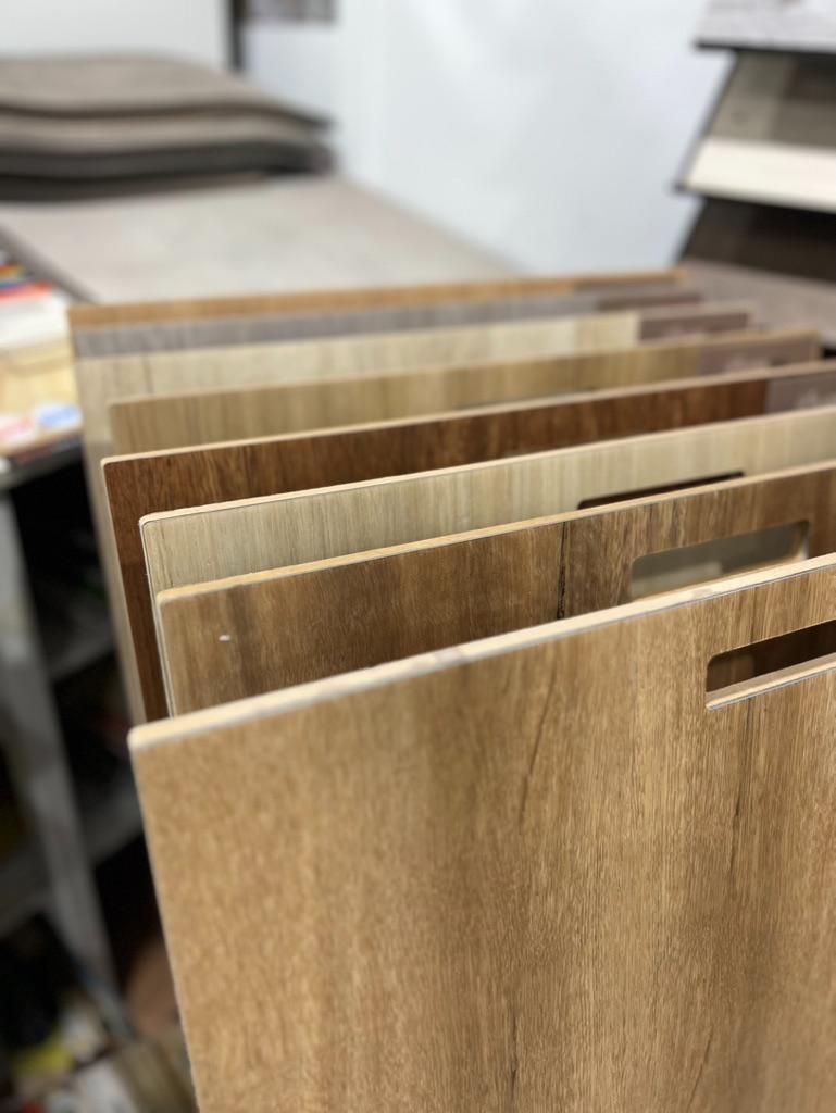 A Bunch of Wooden Boards Are Stacked on Top of Each Other on a Table — Traditional Tiles & Flooring In Woree, QLD