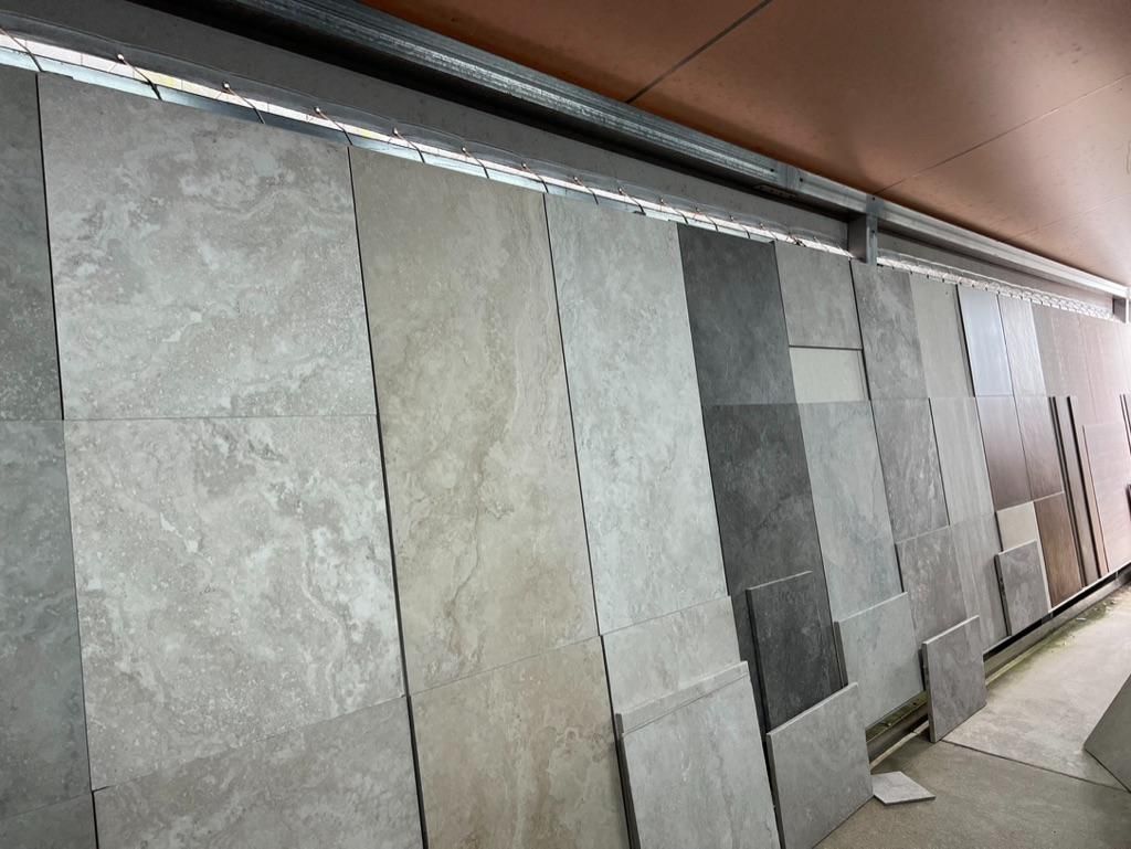 A Row of Tiles Are Lined Up Against a Wall in a Store — Traditional Tiles & Flooring In Woree, QLD