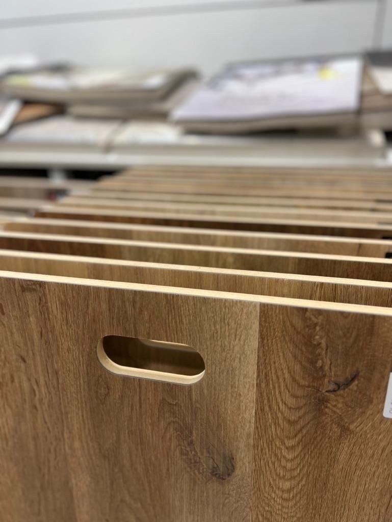A Row of Wooden Boards With Holes in Them Are Sitting on a Table — Traditional Tiles & Flooring In Woree, QLD