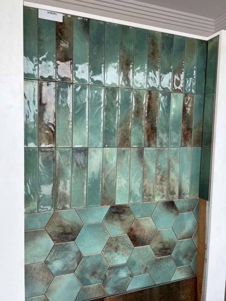 A Wall With a Lot of Green Tiles on It — Traditional Tiles & Flooring In Woree, QLD