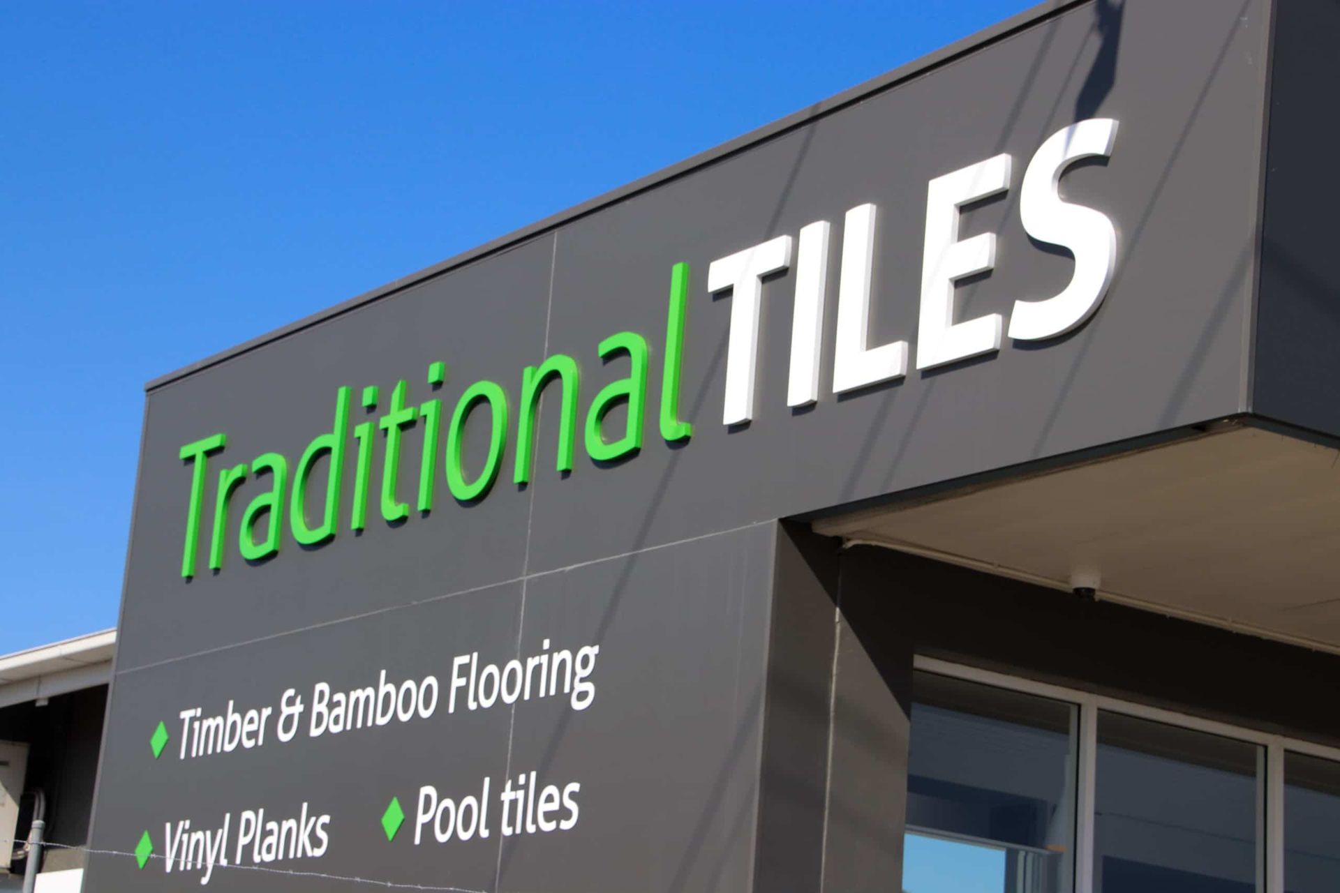 A Building with A Sign that Says Traditional Tiles on It — Traditional Tiles & Flooring In Woree, QLD